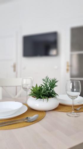 a dining table with two plates and glasses on it at Finnem Rentals Zíkova in Prague