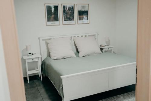 a bedroom with a white bed with two night stands at Ferienhaus Stiefel in Schutterwald
