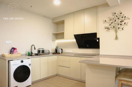a kitchen with a washer and dryer in it at The Aru Hotel at Aru Suites in Kota Kinabalu