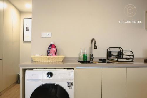 a kitchen with a dishwasher and a counter top at The Aru Hotel at Aru Suites in Kota Kinabalu
