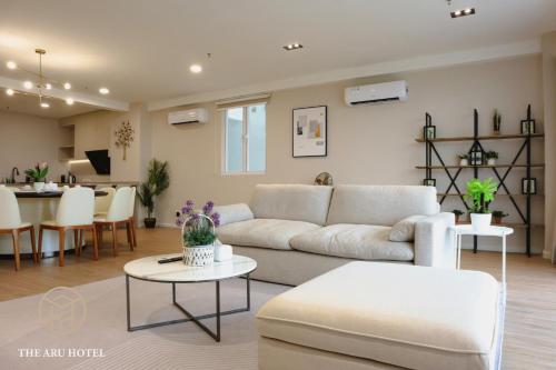 a living room with a couch and a table at The Aru Hotel at Aru Suites in Kota Kinabalu