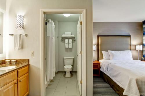 a bedroom with a bed and a toilet and a sink at Homewood Suites by Hilton Stratford in Stratford