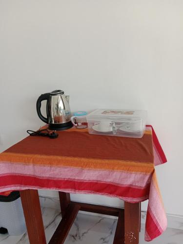 a table with a tea kettle on top of it at Ella glory inn in Ella