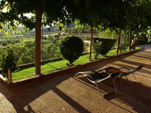 a chair sitting on the ground in front of a garden at Suite Rural Carenas in Carenas