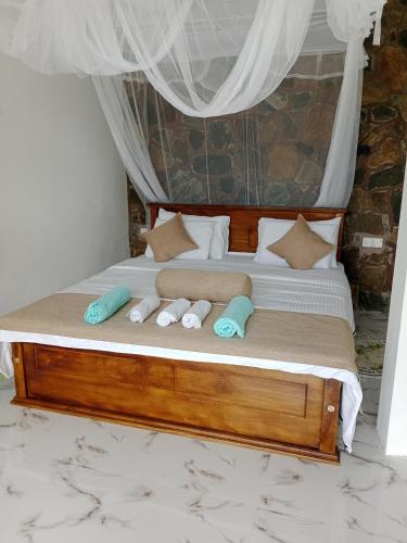 a bedroom with a bed with two pillows on it at Ella glory inn in Ella