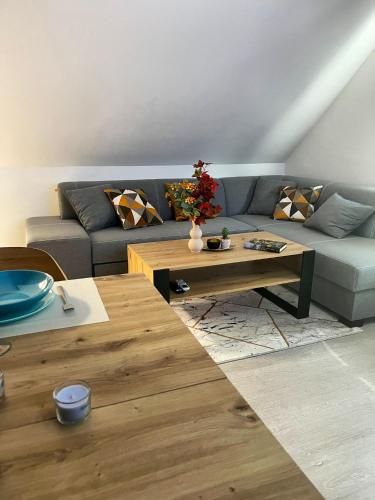 a living room with a couch and a coffee table at Apartamenty Lumax in Gryfice
