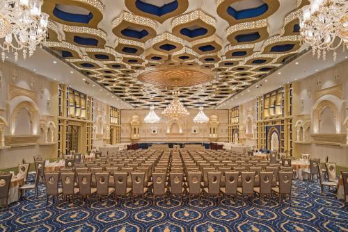 a large banquet hall with chairs and a chandelier at Radisson Blu Udaipur Palace Resort & Spa in Udaipur