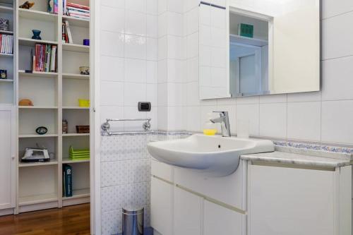 a white bathroom with a sink and a mirror at Vodice Flexyrent apartment in Milan