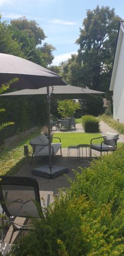 a group of chairs and an umbrella on a patio at Intermezzo Emmerich in Emmerich