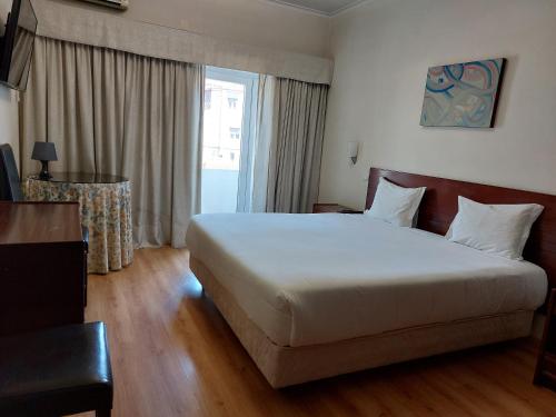 Ένα ή περισσότερα κρεβάτια σε δωμάτιο στο Petrus Hotel