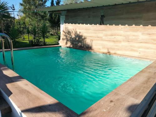 a swimming pool with blue water in a backyard at FINCA RIODIEL in Gibraleón
