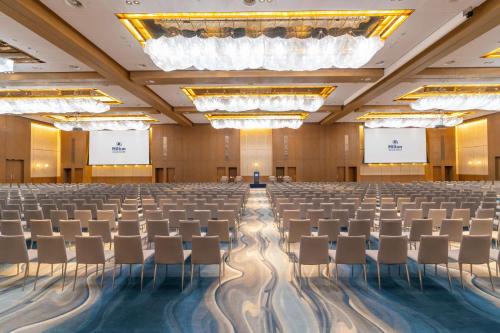 an empty conference room with rows of chairs in the middle at Hilton Abu Dhabi Yas Island in Abu Dhabi