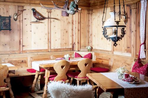 a dining room with wooden walls and a table and chairs at Hotel Frankenland in Bad Kissingen