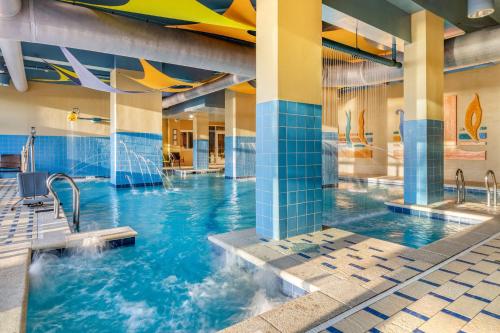 a swimming pool in a building with blue tiles at Hilton Vacation Club Ocean Beach Club Virginia Beach in Virginia Beach