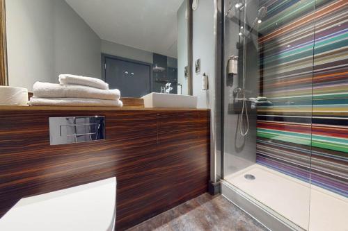 a bathroom with a shower and a sink at Village Hotel Swansea in Swansea