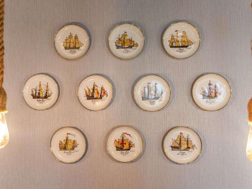a bunch of plates hanging on a wall at Ibis Styles El Malecon Guayaquil in Guayaquil