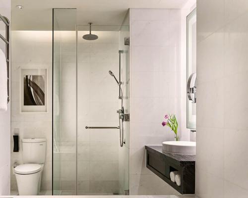 a bathroom with a shower and a toilet and a sink at Hotel Sor in Phnom Penh