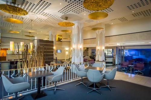 a restaurant with chairs and a table in a room at Hotel Frankenland in Bad Kissingen