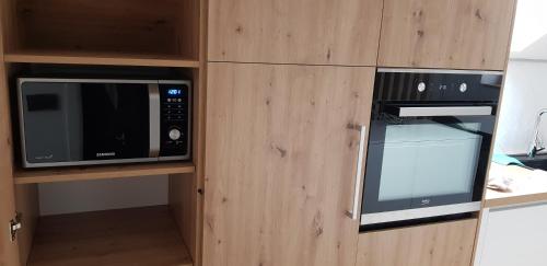 a kitchen with two microwaves and a microwave at AppPrusnik in Ljubljana