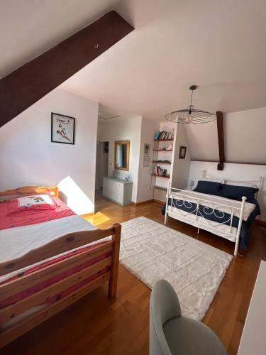 a bedroom with a bed and a crib at La Maisonnette in Les Pieux