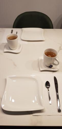 two cups of coffee sitting on a table at AppPrusnik in Ljubljana