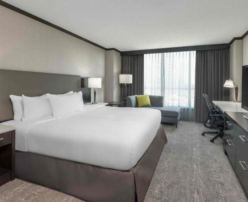 a large white bed in a hotel room at Hilton Vancouver Metrotown in Burnaby