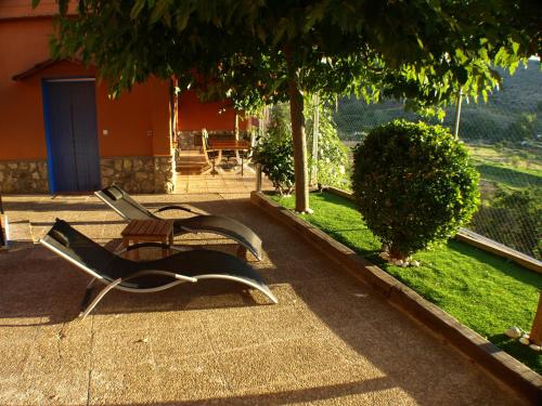 a park bench sitting on the side of a sidewalk at Suite Rural Carenas in Carenas