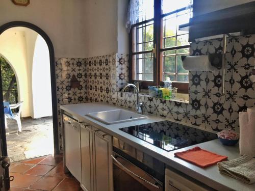 a kitchen with a sink and a counter top at Gioconda Villa in Varenna