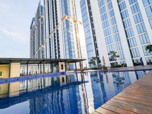 a swimming pool in a city with tall buildings at lovina 1515 at Pollux Meisterstadt in Batam Center