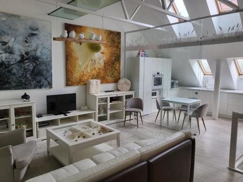 a living room with a couch and a table at Gallery Balta Apartments in Kaunas