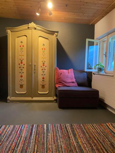 a living room with a couch and a cabinet at Haus I'mperfect in Stumm