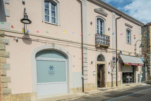 a building with a door on a street at TANIT ROOMS & SPA in Villasimius