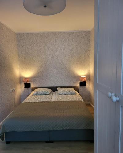 a bedroom with a large bed with two pillows at The entire comfortable apartment in Rakvere