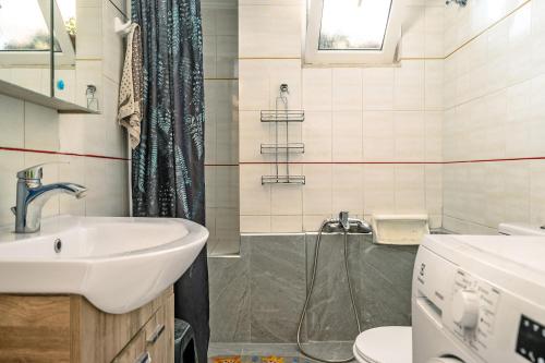 a bathroom with a sink and a shower at Nice central family apartment in Gastoúni