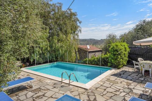 a swimming pool in a yard with a table and chairs at Casa Paola e del Poeta in Costa Carnara