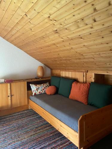 a bed in a room with a wooden ceiling at Haus I'mperfect in Stumm