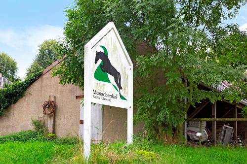 a sign in front of a building with a penguin at Tiny Appartment Xanten am See in Xanten