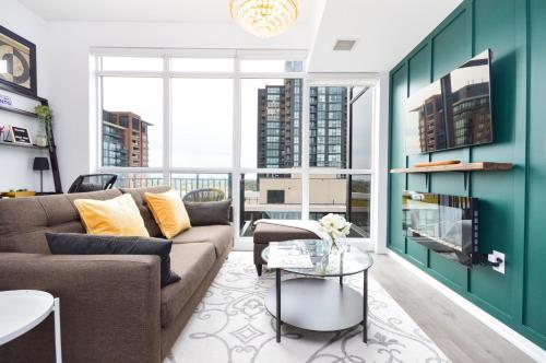 a living room with a couch and a table at The Splendid - Luxury 1BR Uptown Toronto in Toronto