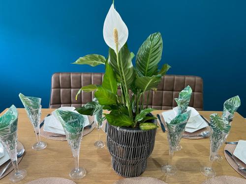 a plant in a vase sitting on top of a table at Large NEW Detached House Woolton, Families, FREE Parking, Massage, BBQ, Play room & MORE in Woolton