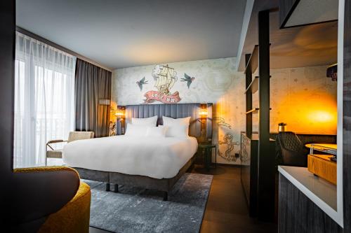 a hotel room with a large bed and a couch at NYX Hotel Hamburg by Leonardo Hotels in Hamburg