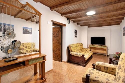 a living room with two chairs and a television at los diablitos 2b in San Juan de la Rambla