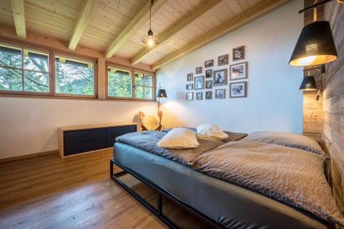 a bedroom with a bed in a room with windows at Valentin36 Apartment Ritten in Funes