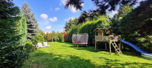 a yard with a tree house and a playground at Hotel Villa Verde in Düsseldorf
