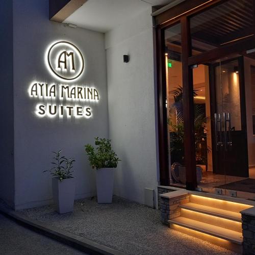 a sign on the side of a building at Ayia Marina Suites in Ouranoupoli