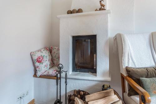 a living room with a fireplace and a chair at Ferienappartement 2 - Lockstein in Berchtesgaden