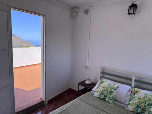 Un dormitorio con una cama y vista al mar. en Villa Almagre, en Gáldar