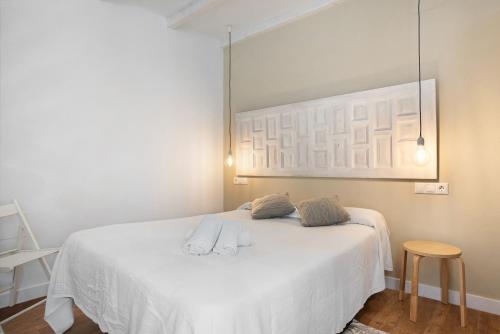 Un dormitorio con una cama blanca con dos toallas encima. en Estudio Clara 1, en Conil de la Frontera