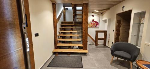 a spiral staircase in a room with a chair at AppPrusnik in Ljubljana