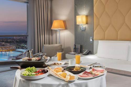 a tray of food on a table in a hotel room at Elexus Hotel Resort & Spa & Casino in Kérynia