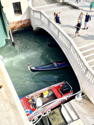 a boat in the water under a bridge at The B Collection - San Marco Riva schiavoni in Venice